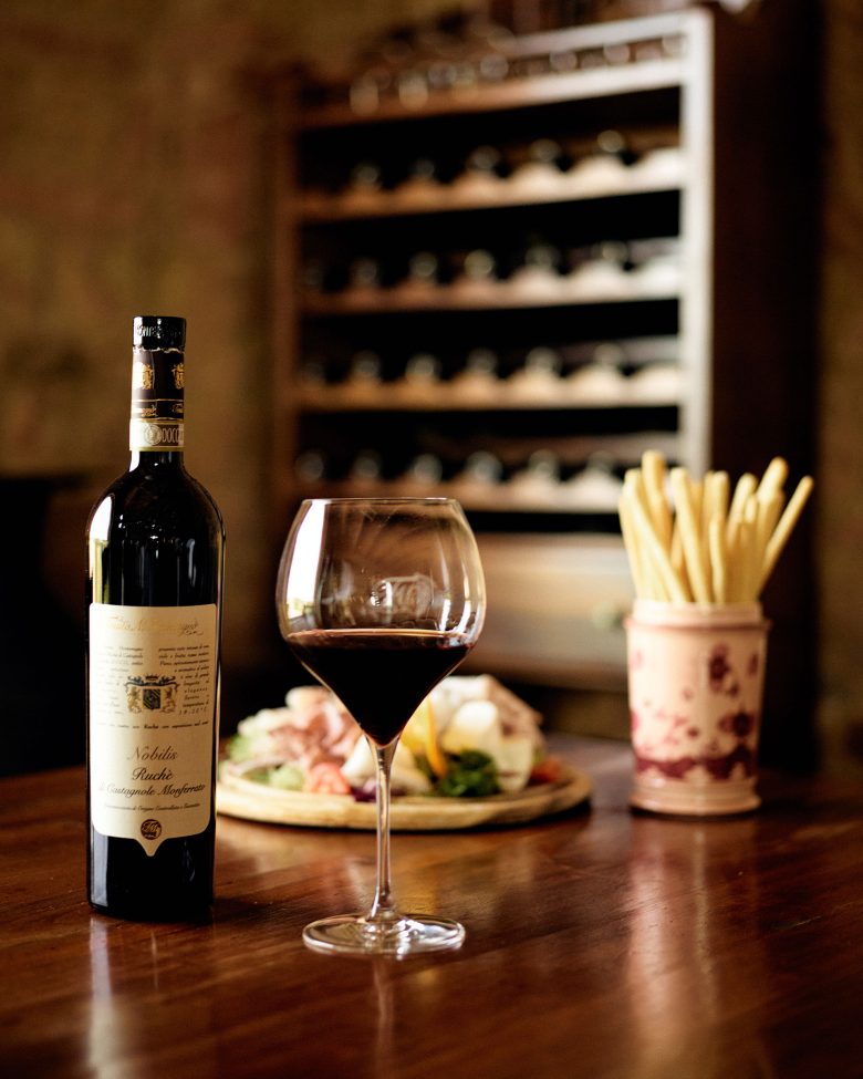 Fine wine and appetizers at a luxury estate showcasing TM Relais' exquisite hospitality experience.